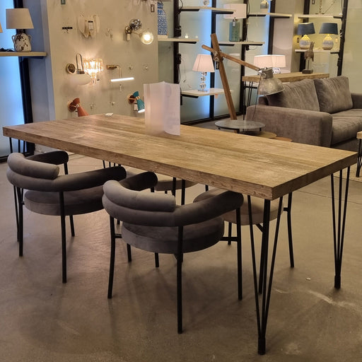  The Belgrade Rustic Farm Dining Table features a solid pine wood tabletop with natural grain patterns, supported by sturdy black metal legs, offering a blend of rustic charm and modern industrial style.