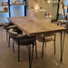 The Belgrade Rustic Farm Dining Table in a well-lit dining room, showcasing its inviting design and versatility in any space, perfect for family meals and gatherings.