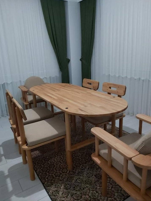 Elegant beech wood dining table showcasing its smooth oval-shaped top and minimalist design.