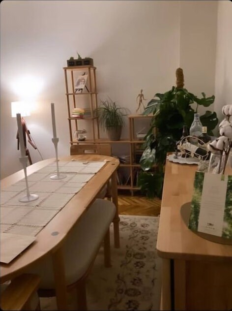 Room setup featuring the dining table styled with modern chairs and simple decor
