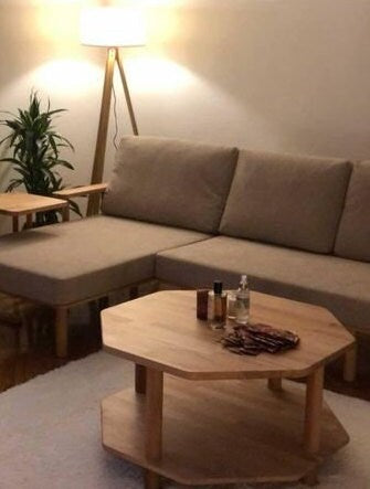 Decorative items on the coffee table: The table adorned with books and a vase, illustrating its functional surface area.