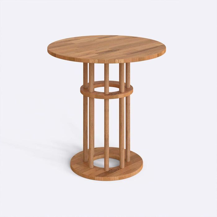 Side view of the Grant Dining Table showcasing the sturdy wood legs and simple round design.