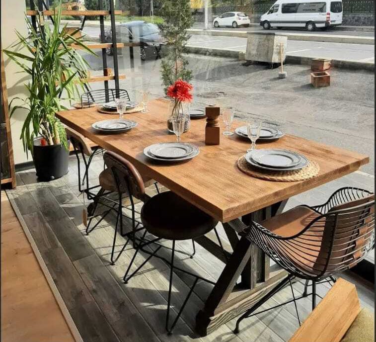Side angle of the Table, showing the sturdy wooden legs and rustic charm