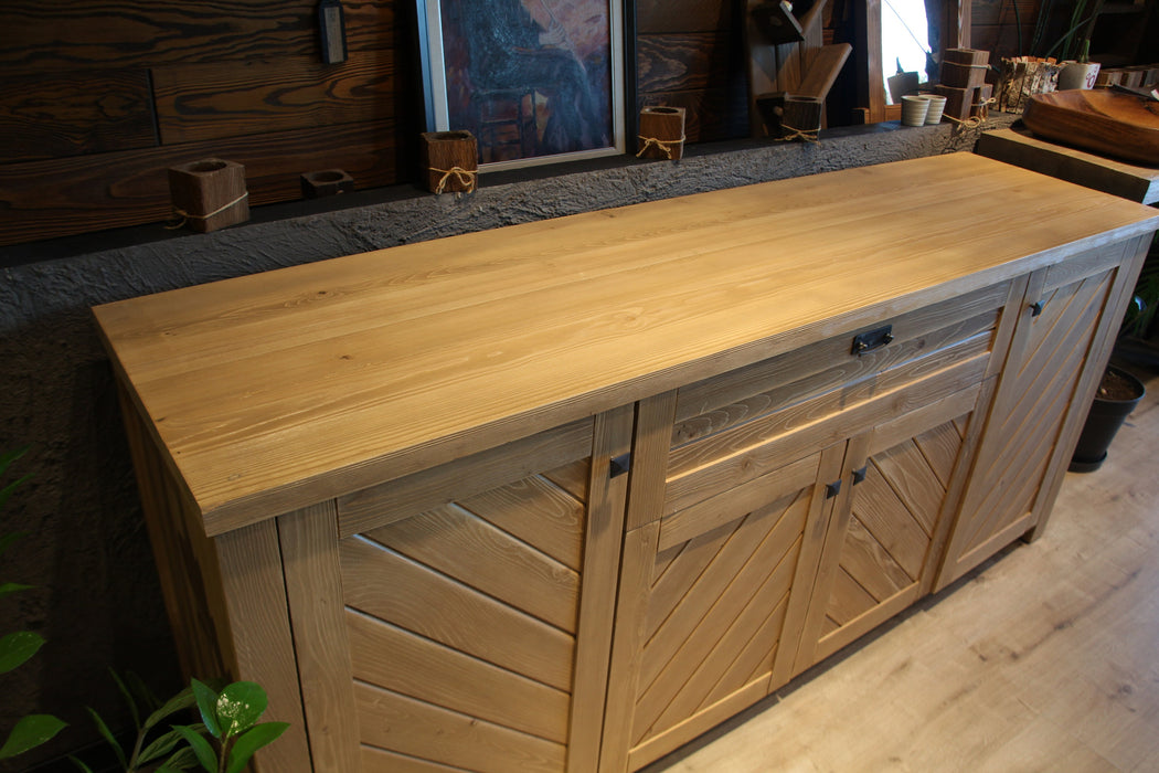 Wide shot of the sideboard in a modern dining room, styled for a contemporary farmhouse aesthetic.