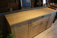 Wide shot of the sideboard in a modern dining room, styled for a contemporary farmhouse aesthetic.