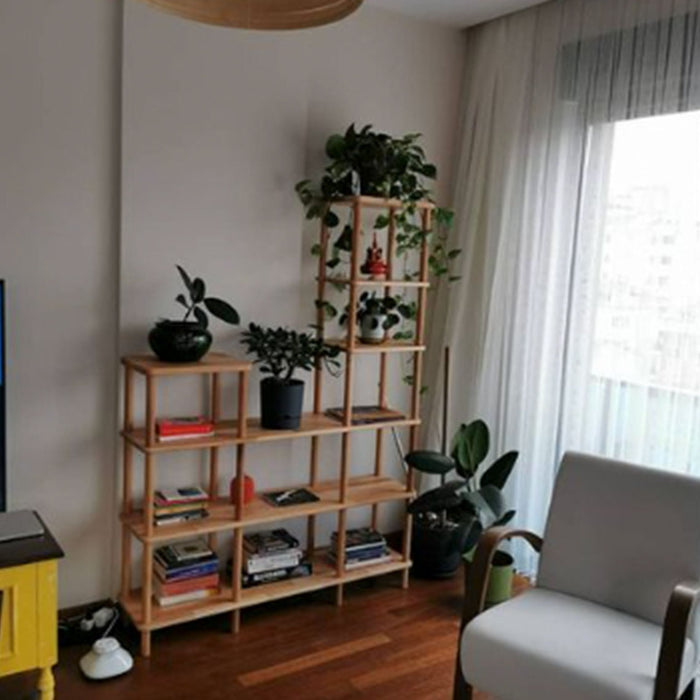 Styled in a modern living room, the open shelves display books and decorative items, seamlessly fitting into the room’s contemporary design.