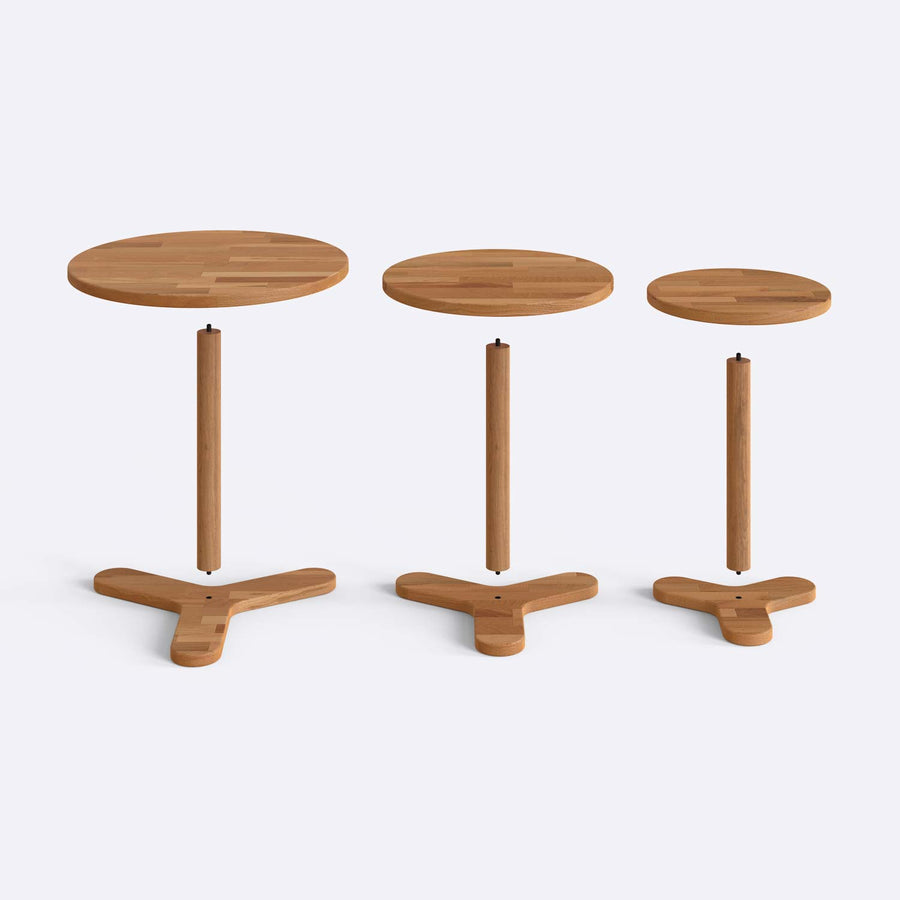 Side angle of Table Set showing the round shape and sturdy wood legs of the modern tables