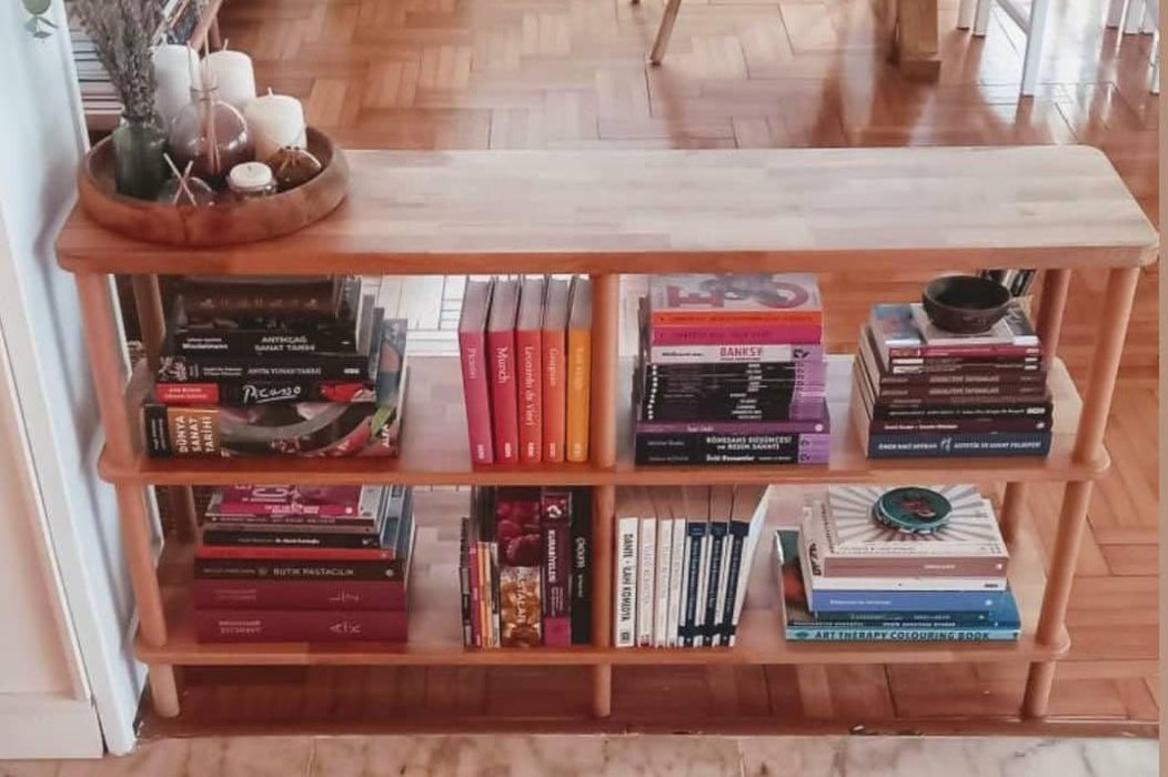 Detailed view of the natural wood bookshelf, showing the precise craftsmanship and elegant finish.