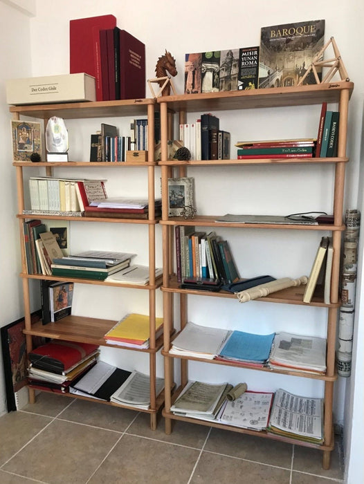  The bookcase styled with a mix of books, plants, and framed photos, demonstrating its versatility.