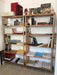 The bookcase styled with a mix of books, plants, and framed photos, demonstrating its versatility.