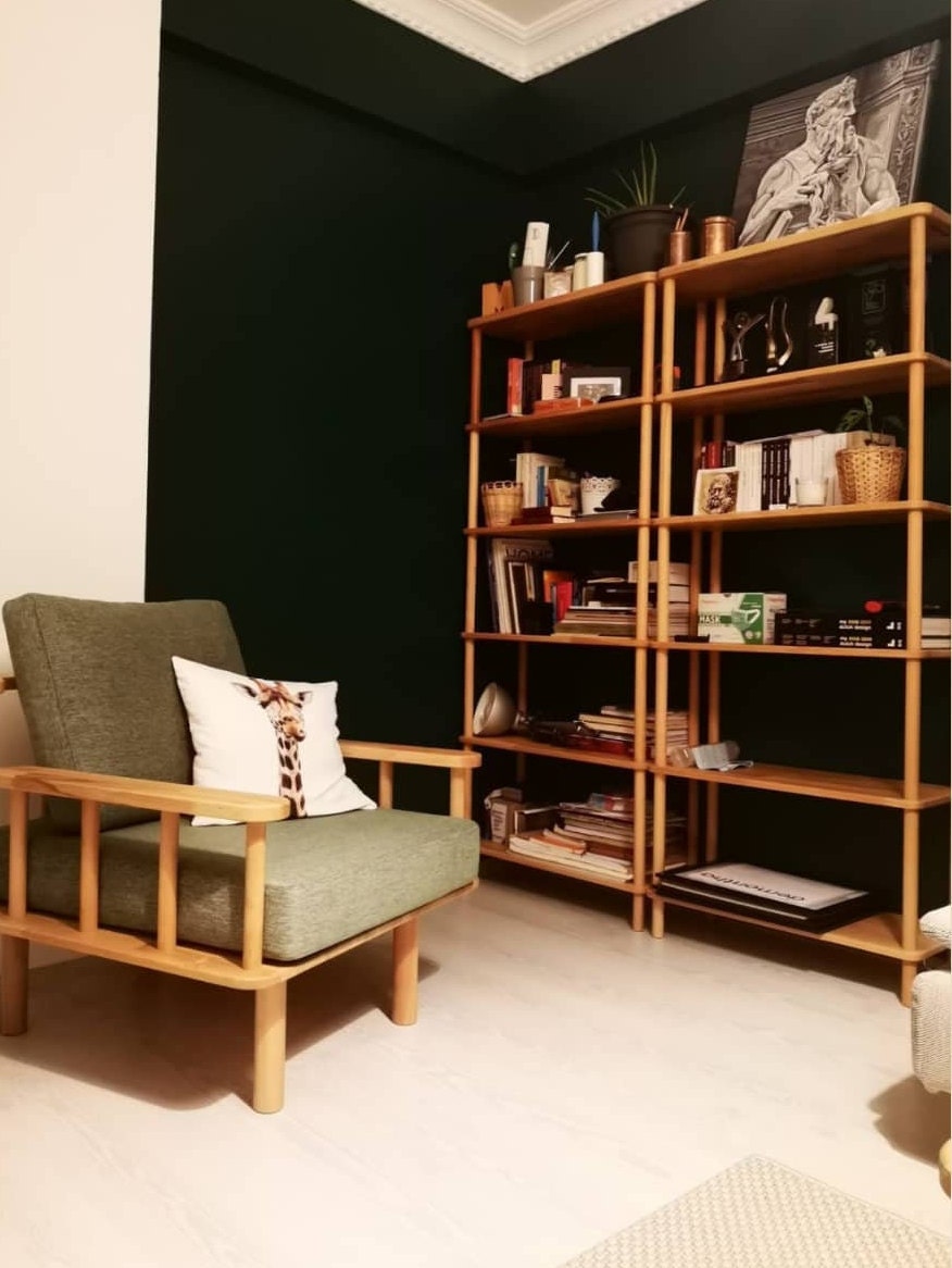 The bookcase in a home office setup, neatly holding books, files, and decor.