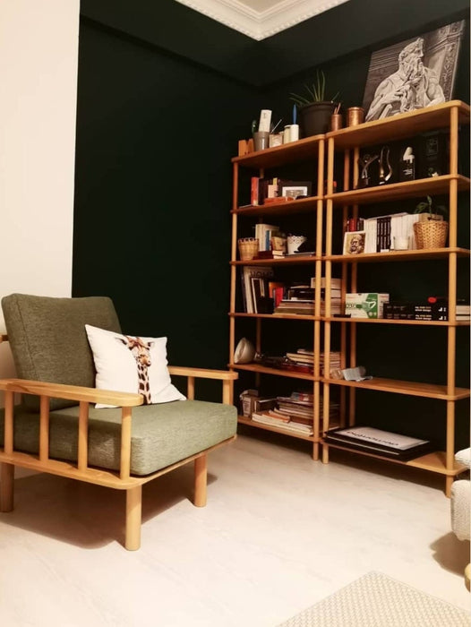 The bookcase in a home office setup, neatly holding books, files, and decor.