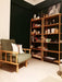 The bookcase in a home office setup, neatly holding books, files, and decor.