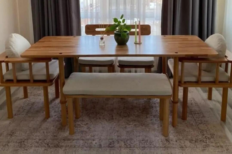 Dining table bathed in natural light, showing the refined wood grain.