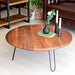 Front view of the Spark Walnut Wood Round Coffee Table – A sleek round coffee table crafted from solid walnut wood, featuring a rich natural finish and sturdy black metal legs.