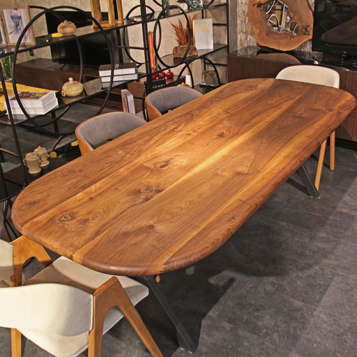 Front view of the Toledo walnut wooden dining table, showcasing its sleek metal legs and smooth wooden surface.