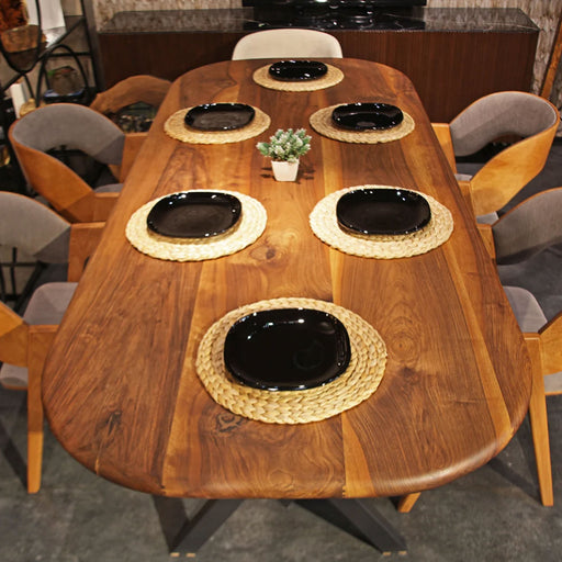 Close-up of the rich walnut finish on the wooden dining table, highlighting the fine craftsmanship and natural wood grain.